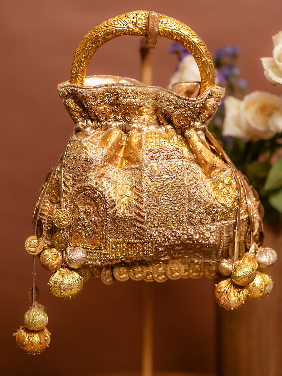 Detail of Abha hasli beige potli embroidery and tassels — Ozel