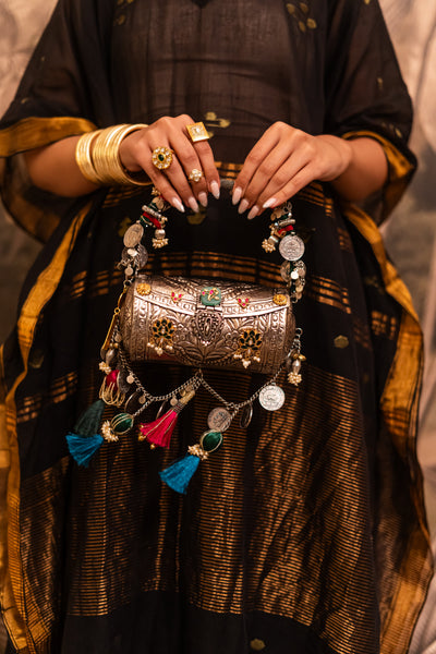 Side view of Tara tribal handbag with floral metalwork — Ozel