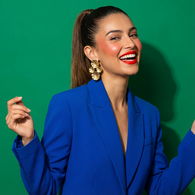 Radiant sunburst drop earrings gold – worn on ear by Ozel