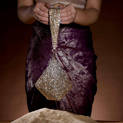 Pyramid rhinestone clutch held by model — Ozel