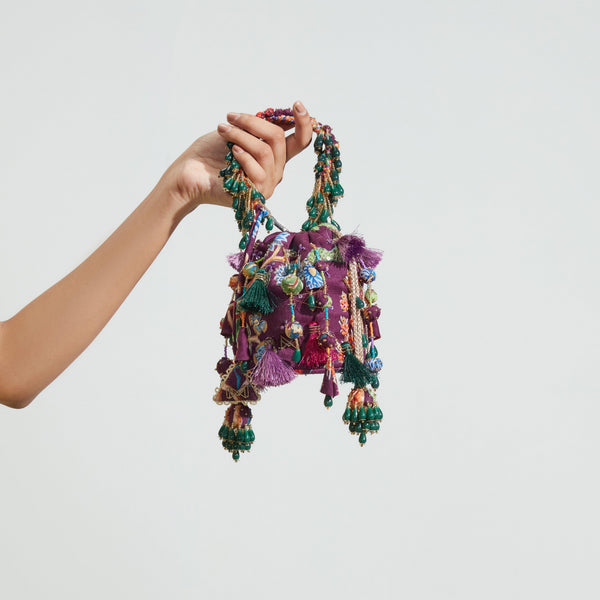 Purple embroidered drawstring bucket bag with tasselled accents — Ozel