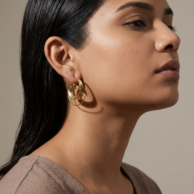 Classic gilded hoop earrings – worn on ear by Ozel