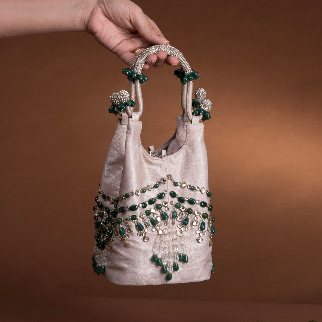 Side view of Panna emerald kundan bucket bag — Ozel