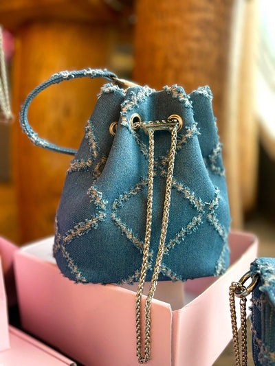 Distressed denim bucket bag with handcrafted detailing — Ozel