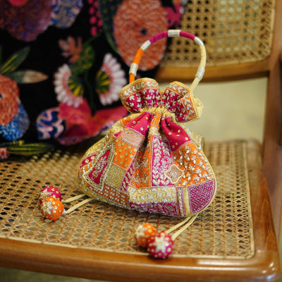 Multicolor patchwork embroidered potli bag with jadau motifs