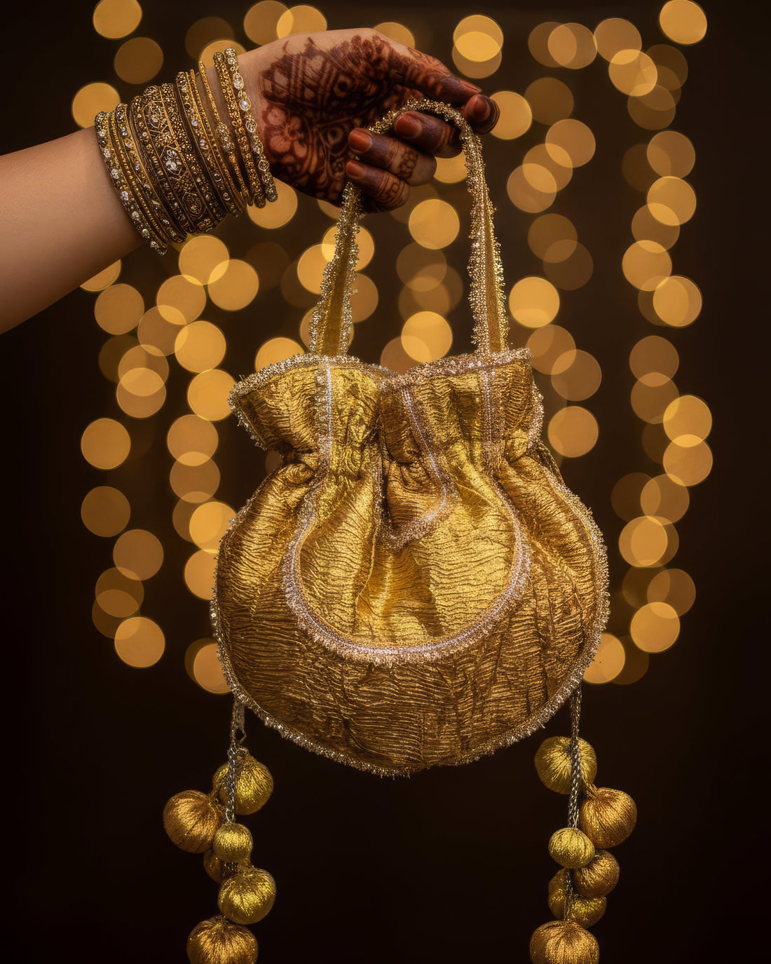 Shashi gold-gota embroidered potli bag with handmade tassels — Ozel