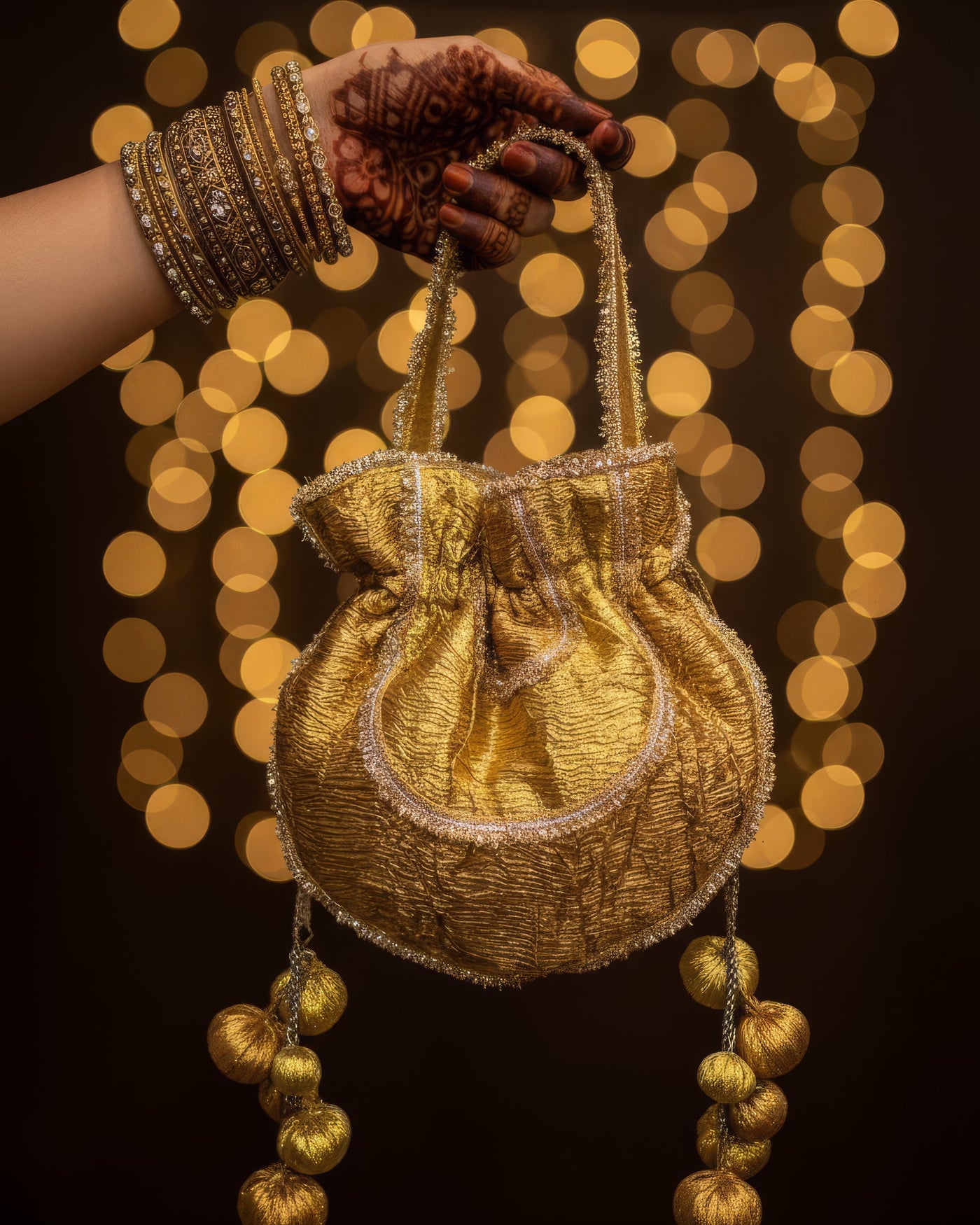 Shashi gold-gota embroidered potli bag with handmade tassels — Ozel