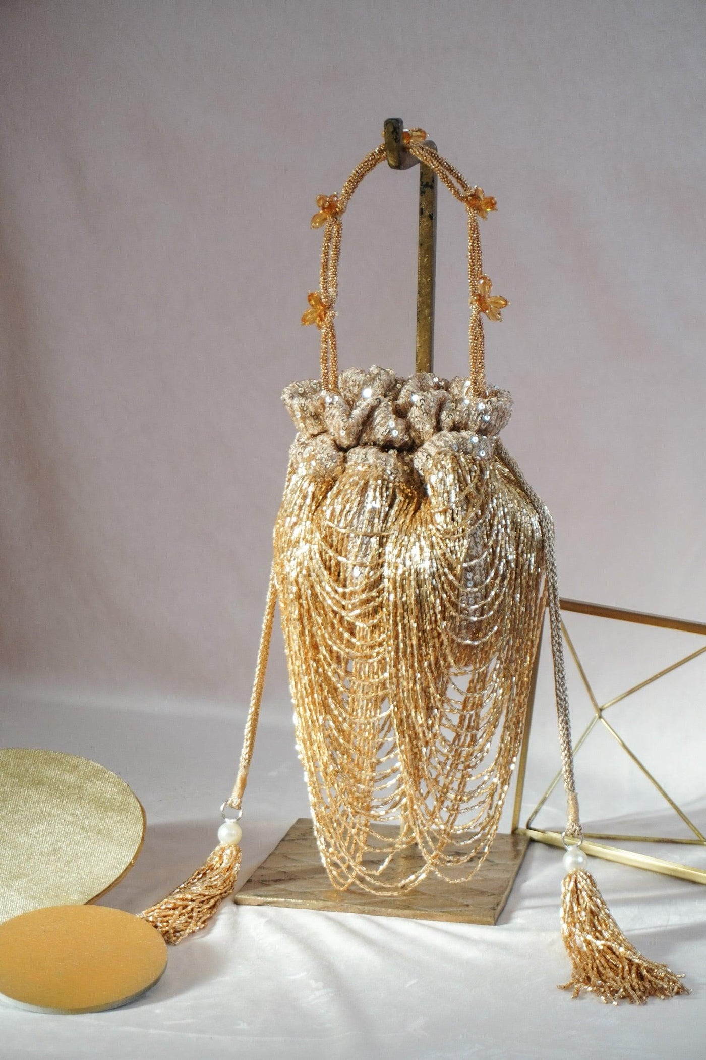 Dragon's Nest shimmer potli bag with embroidered detail — Ozel